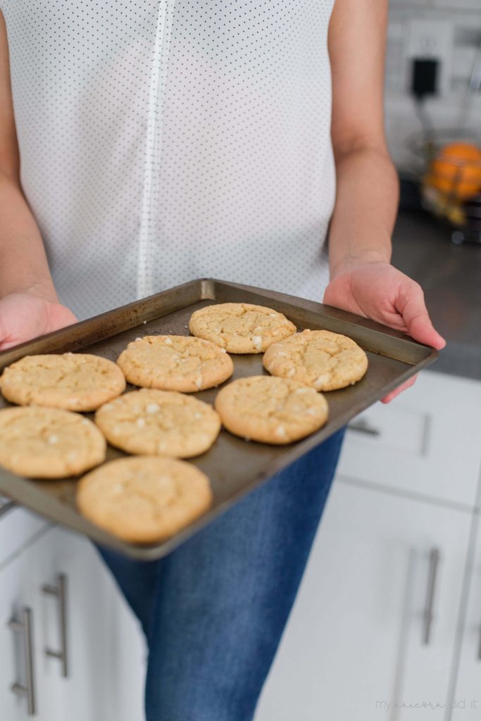 girl holding a pan of cookies
